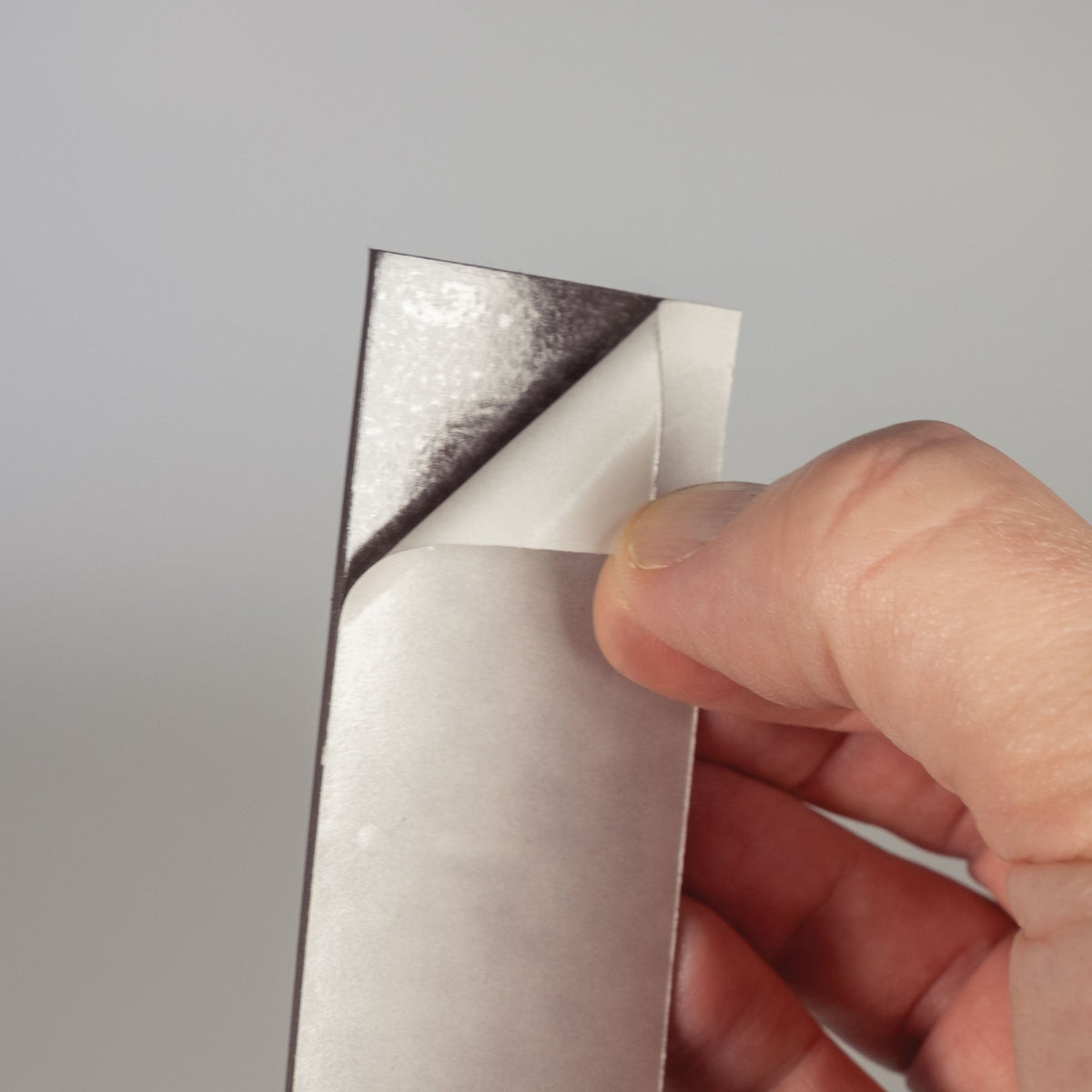 MAGSTRIP815 Adhesive Backed Magnetic Strip for Securing L-Bend Series Signs (8 in x 1.5 in) with the liner being removed from the adhesive