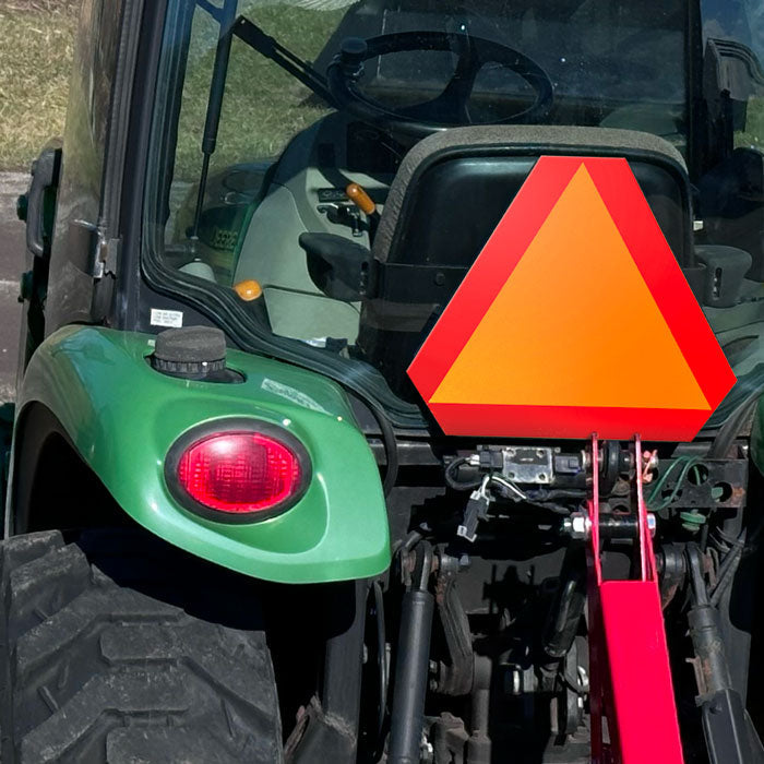 TS8021AR Slow Moving Vehicle Aluminum Reflective Sign (14 in x 16 in) attached to the back of a tractor
